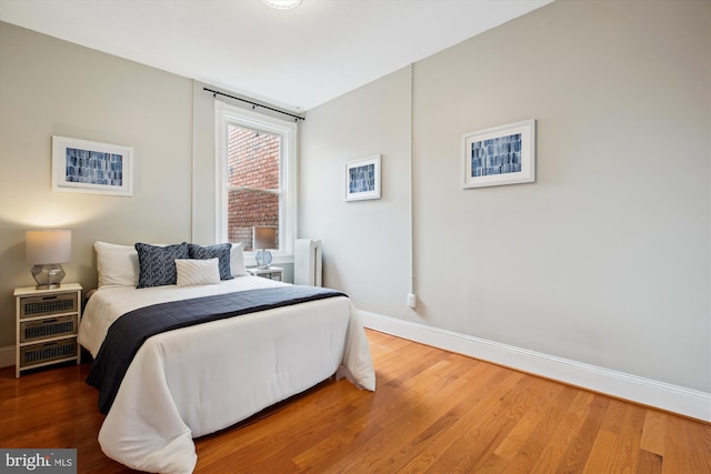 609 Elliott St NE, Washington, DC 20002 - bedroom featuring radiator heating unit and wood finished floors