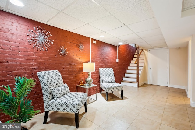 609 Elliott St NE, Washington, DC 20002 - living area with a drop ceiling, stairway, brick wall, tile patterned floors, and recessed lighting