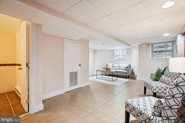 609 Elliott St NE, Washington, DC 20002 - living area featuring light tile patterned floors and a paneled ceiling