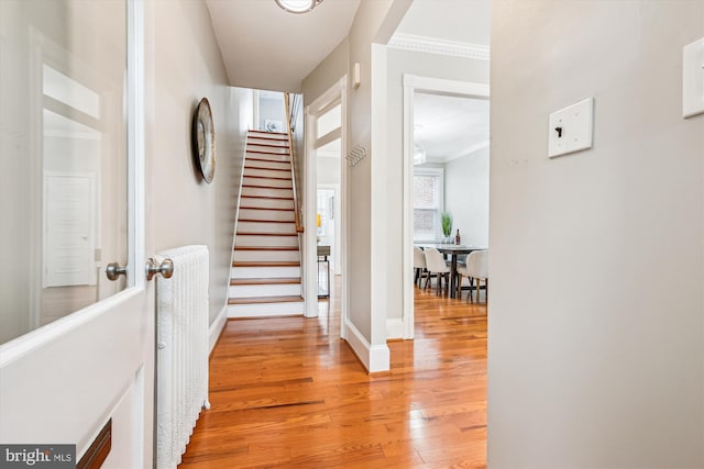 609 Elliott St NE, Washington, DC 20002 - hallway with light wood-type flooring, stairway, and crown molding