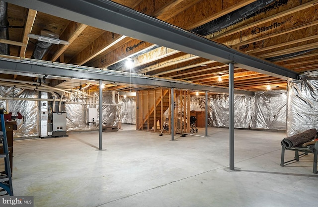 13 Wauwinet Ct, Rehoboth Beach, DE 19971 - unfinished below grade area with heating unit, stairs, and water heater