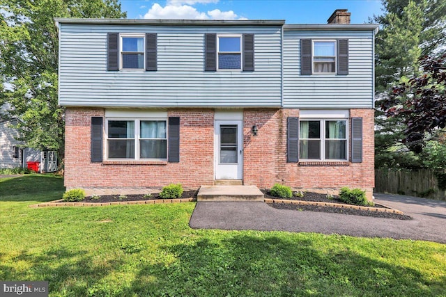 1048 Acorn, Stowe, PA 19464 - view of front facade with a chimney, a front lawn, and brick siding