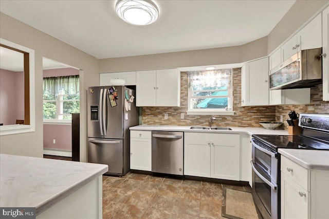 1048 Acorn, Stowe, PA 19464 - kitchen featuring stainless steel appliances, a baseboard heating unit, light countertops, and backsplash