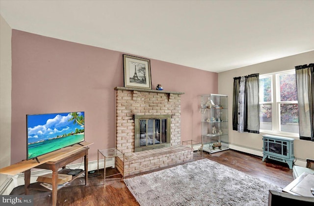 1048 Acorn, Stowe, PA 19464 - living area with dark wood-style floors, a baseboard radiator, a brick fireplace, and a wood stove