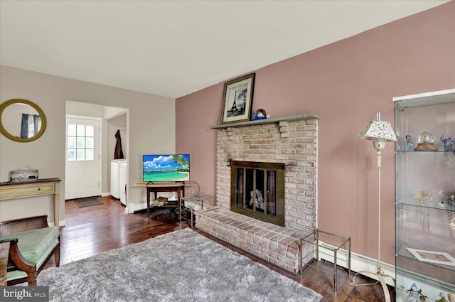 1048 Acorn, Stowe, PA 19464 - living area with a brick fireplace, wood finished floors, and a baseboard heating unit