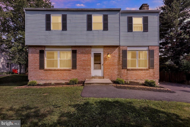 1048 Acorn, Stowe, PA 19464 - view of front of property featuring a chimney, brick siding, and a front lawn