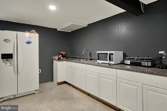 1048 Acorn, Stowe, PA 19464 - kitchen featuring white appliances, white cabinetry, concrete flooring, and dark stone countertops