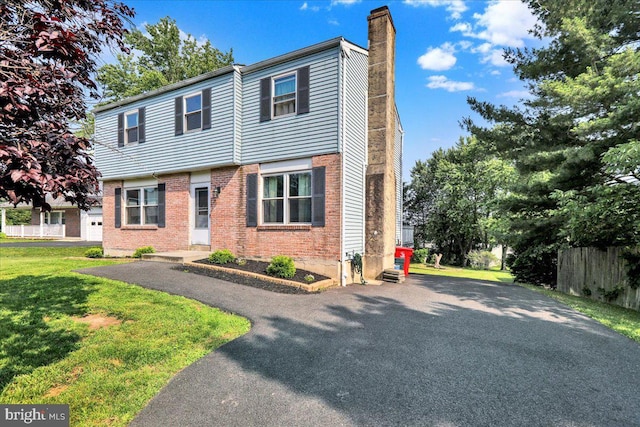 1048 Acorn, Stowe, PA 19464 - view of front facade with a chimney, brick siding, and asphalt driveway