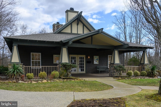 1305 S Branch Dr, Whitehouse Station, NJ 08889 - back of property with a shingled roof, a porch, a chimney, and a lawn
