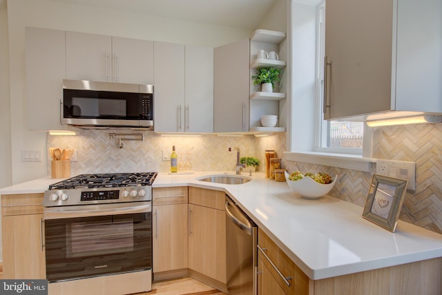 921 S Conestoga St, Philadelphia, PA 19143 - kitchen featuring stainless steel appliances, open shelves, decorative backsplash, light countertops, and light brown cabinets