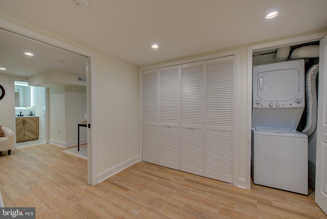 921 S Conestoga St, Philadelphia, PA 19143 - laundry room featuring stacked washing machine and dryer, light wood finished floors, and recessed lighting