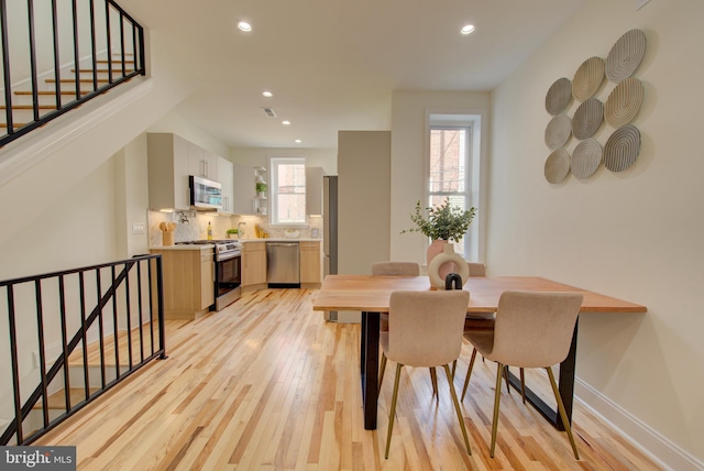 921 S Conestoga St, Philadelphia, PA 19143 - dining space with light wood-style flooring, recessed lighting, and stairway