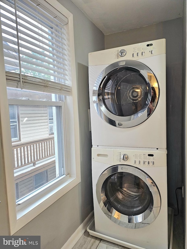 18 N 5th St, Columbia, PA 17512 - washroom with stacked washer and clothes dryer and wood finished floors
