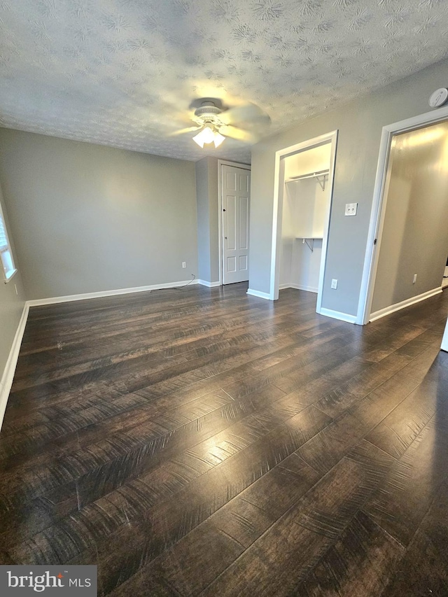18 N 5th St, Columbia, PA 17512 - unfurnished bedroom with dark wood-style flooring, a textured ceiling, and a ceiling fan