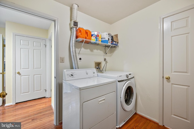 12330 Needlepine Ter, Silver Spring, MD 20904 - laundry area featuring washer and dryer and light wood-style floors
