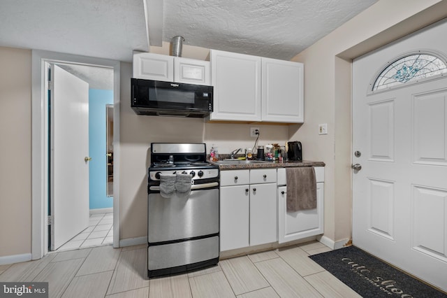 12330 Needlepine Ter, Silver Spring, MD 20904 - kitchen featuring gas range, black microwave, white cabinets, dark countertops, and a textured ceiling