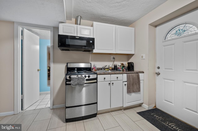 12330 Needlepine Ter, Silver Spring, MD 20904 - kitchen with gas range, black microwave, white cabinets, dark countertops, and a textured ceiling