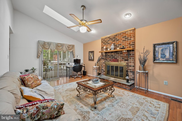 12330 Needlepine Ter, Silver Spring, MD 20904 - living room with a brick fireplace, a skylight, a ceiling fan, wood finished floors, and high vaulted ceiling