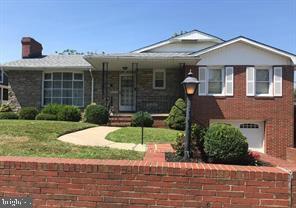 7128 Crestshire, Baltimore, MD 21222 - view of front of property with a front yard, an attached garage, and a chimney