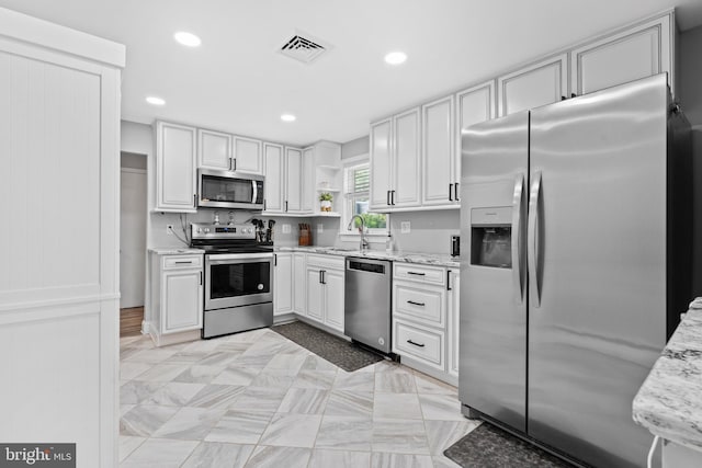566 S Old Middletown Rd, Media, PA 19063 - kitchen featuring appliances with stainless steel finishes, recessed lighting, open shelves, light stone countertops, and white cabinetry
