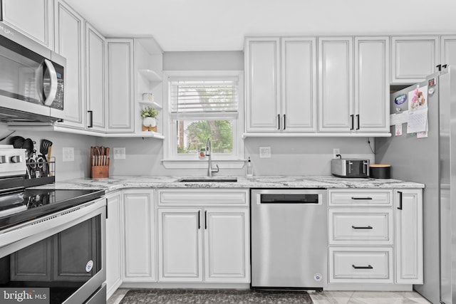 566 S Old Middletown Rd, Media, PA 19063 - kitchen featuring stainless steel appliances, white cabinets, light stone counters, and open shelves