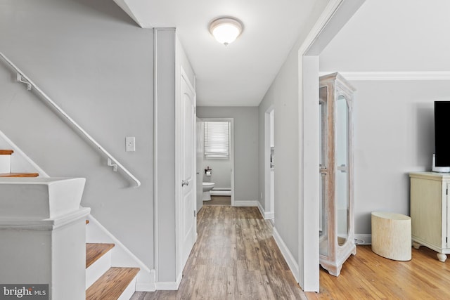 566 S Old Middletown Rd, Media, PA 19063 - hall with light wood finished floors, stairs, and a baseboard heating unit