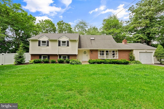 566 S Old Middletown Rd, Media, PA 19063 - tri-level home with a garage, brick siding, a chimney, and driveway