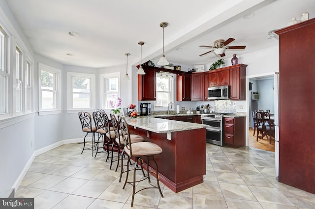 415 Grape St, Hammonton, NJ 08037 - kitchen featuring appliances with stainless steel finishes, dark brown cabinets, a peninsula, and light tile patterned floors