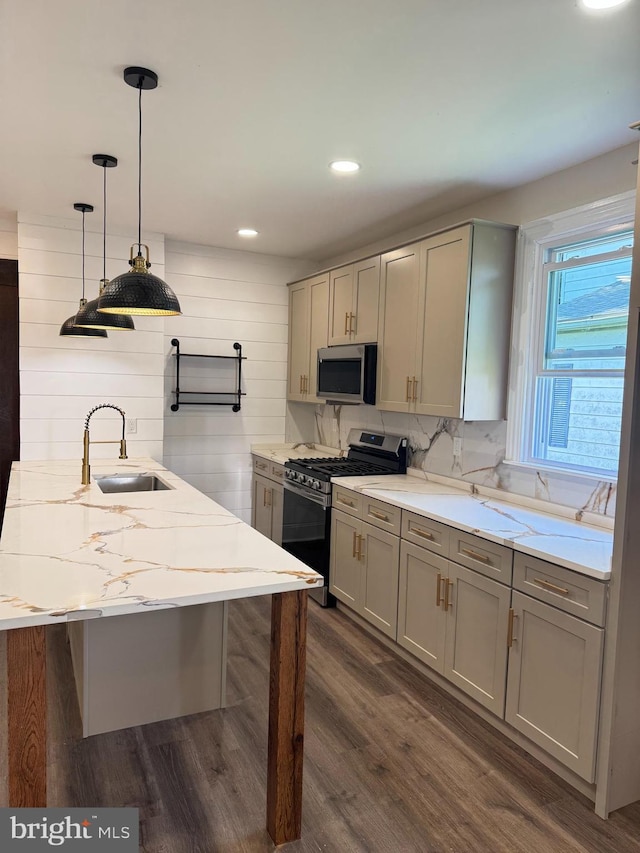 716 S Washington St, Havre De Grace, MD 21078 - kitchen with appliances with stainless steel finishes, gray cabinets, dark wood-style flooring, light stone countertops, and decorative light fixtures