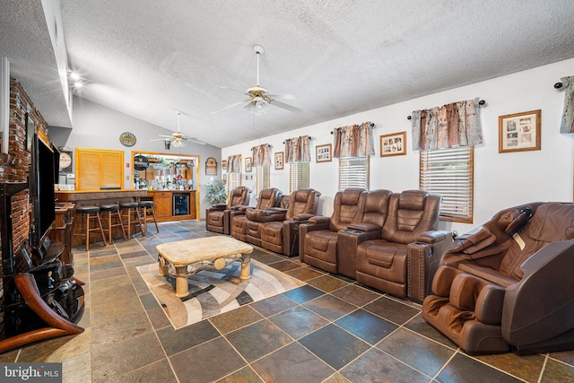 199 Cox Ave, West Creek, NJ 08092 - living area with a textured ceiling, a ceiling fan, vaulted ceiling, a bar, and stone tile floors