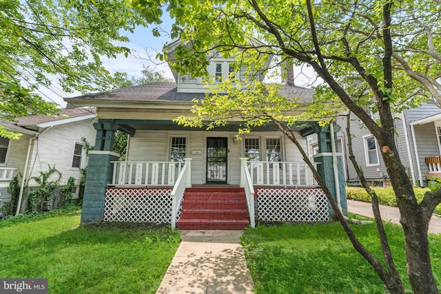 3006 S Dakota Ave NE, Washington, DC 20018 - view of front facade with covered porch, a front yard, and a shingled roof