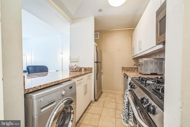 219 S 18th St Unit 1522, Philadelphia, PA 19103 - kitchen featuring washer / clothes dryer, stainless steel appliances, white cabinets, and light stone counters