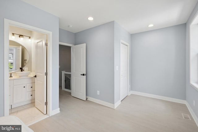 706 Longfellow St NW, Washington, DC 20011 - unfurnished bedroom featuring light wood-style flooring, ensuite bath, and recessed lighting