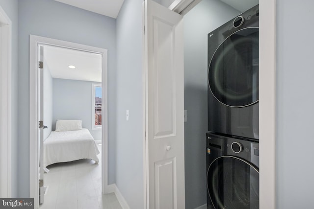 706 Longfellow St NW, Washington, DC 20011 - laundry area featuring stacked washer / dryer and baseboards