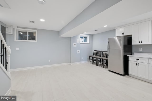 706 Longfellow St NW, Washington, DC 20011 - kitchen with freestanding refrigerator, white cabinets, recessed lighting, and light wood finished floors