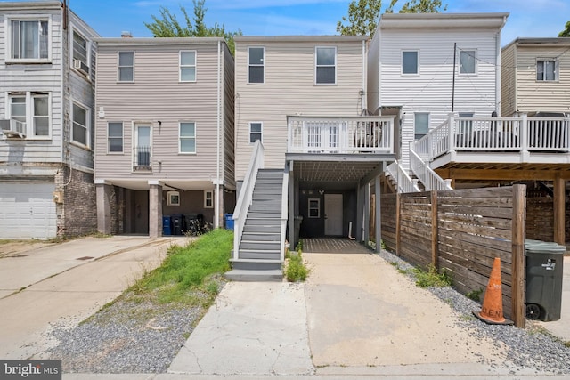 706 Longfellow St NW, Washington, DC 20011 - back of house featuring a carport, stairs, driveway, and a wooden deck