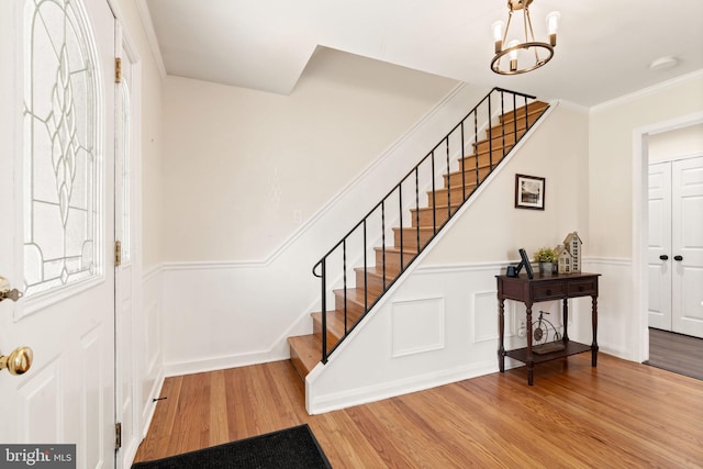 2108 Weatherton Dr, Wilmington, DE 19810 - entryway with stairs, wood finished floors, wainscoting, a chandelier, and crown molding