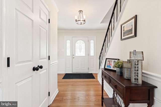 2108 Weatherton Dr, Wilmington, DE 19810 - foyer featuring a chandelier, light wood-type flooring, stairs, ornamental molding, and wainscoting