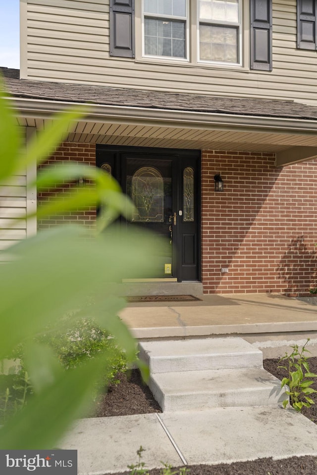 2108 Weatherton Dr, Wilmington, DE 19810 - view of exterior entry with brick siding, a porch, and roof with shingles