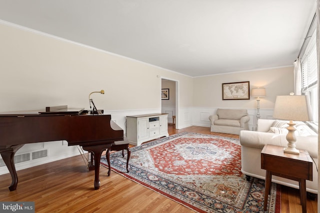 2108 Weatherton Dr, Wilmington, DE 19810 - living area featuring light wood finished floors, crown molding, and a wainscoted wall