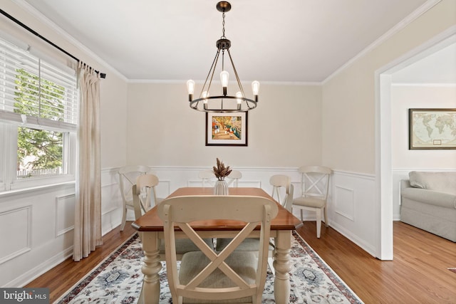 2108 Weatherton Dr, Wilmington, DE 19810 - dining space featuring a chandelier, wood finished floors, ornamental molding, and a wainscoted wall