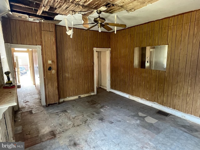 1 N Smallwood St, Baltimore, MD 21223 - unfurnished room featuring a ceiling fan and wood walls