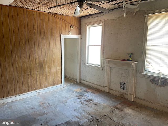 1 N Smallwood St, Baltimore, MD 21223 - unfurnished living room with wooden walls and a ceiling fan