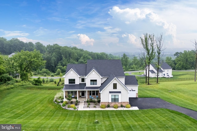 5635 Saucon Ridge Rd, Coopersburg, PA 18036 - modern farmhouse style home with covered porch, board and batten siding, asphalt driveway, a front yard, and a standing seam roof