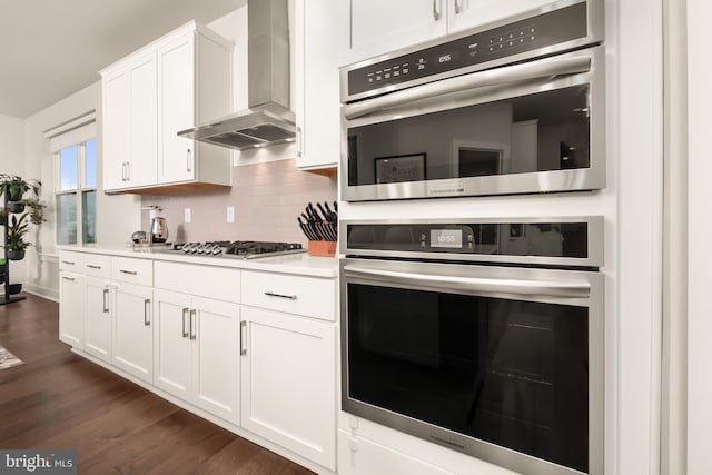 5635 Saucon Ridge Rd, Coopersburg, PA 18036 - kitchen featuring wall chimney range hood, stainless steel appliances, backsplash, white cabinets, and light countertops