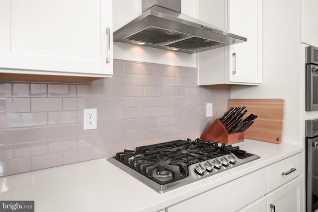 5635 Saucon Ridge Rd, Coopersburg, PA 18036 - kitchen with wall chimney exhaust hood, stainless steel gas cooktop, white cabinetry, light countertops, and backsplash