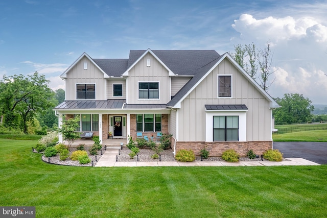 5635 Saucon Ridge Rd, Coopersburg, PA 18036 - modern farmhouse style home with a standing seam roof, covered porch, a front yard, roof with shingles, and a metal roof
