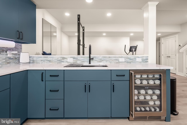 5635 Saucon Ridge Rd, Coopersburg, PA 18036 - kitchen with wine cooler, blue cabinets, backsplash, light countertops, and recessed lighting