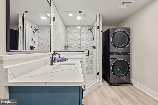 5635 Saucon Ridge Rd, Coopersburg, PA 18036 - full bathroom featuring stacked washer / drying machine, vanity, a stall shower, wood finished floors, and recessed lighting
