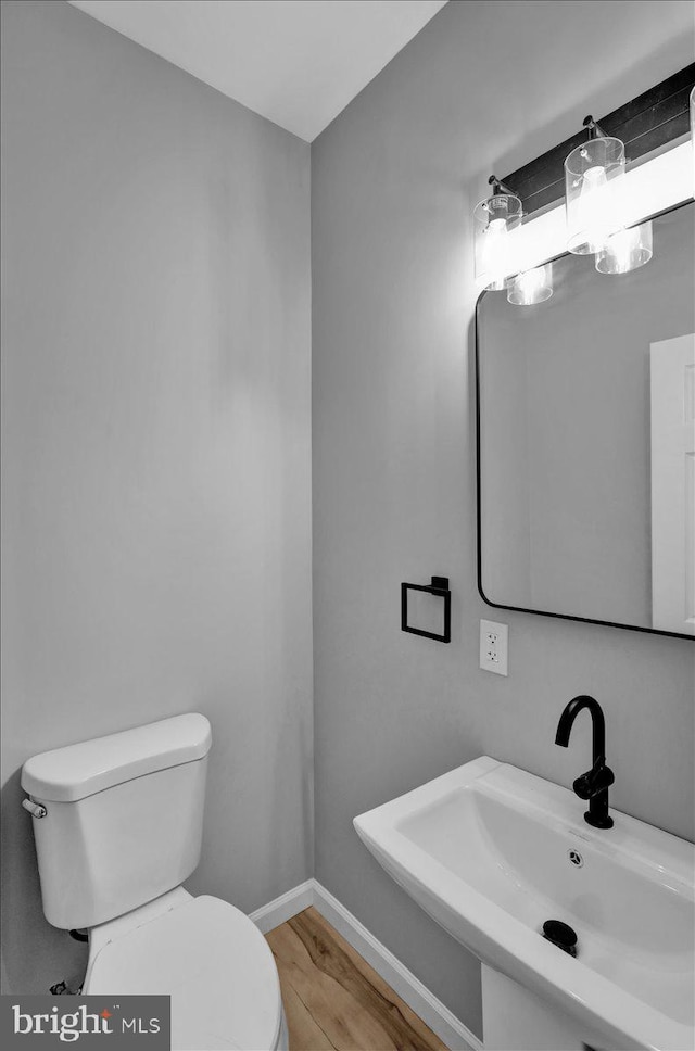 446 S 15th St, Reading, PA 19602 - half bath featuring toilet and wood finished floors